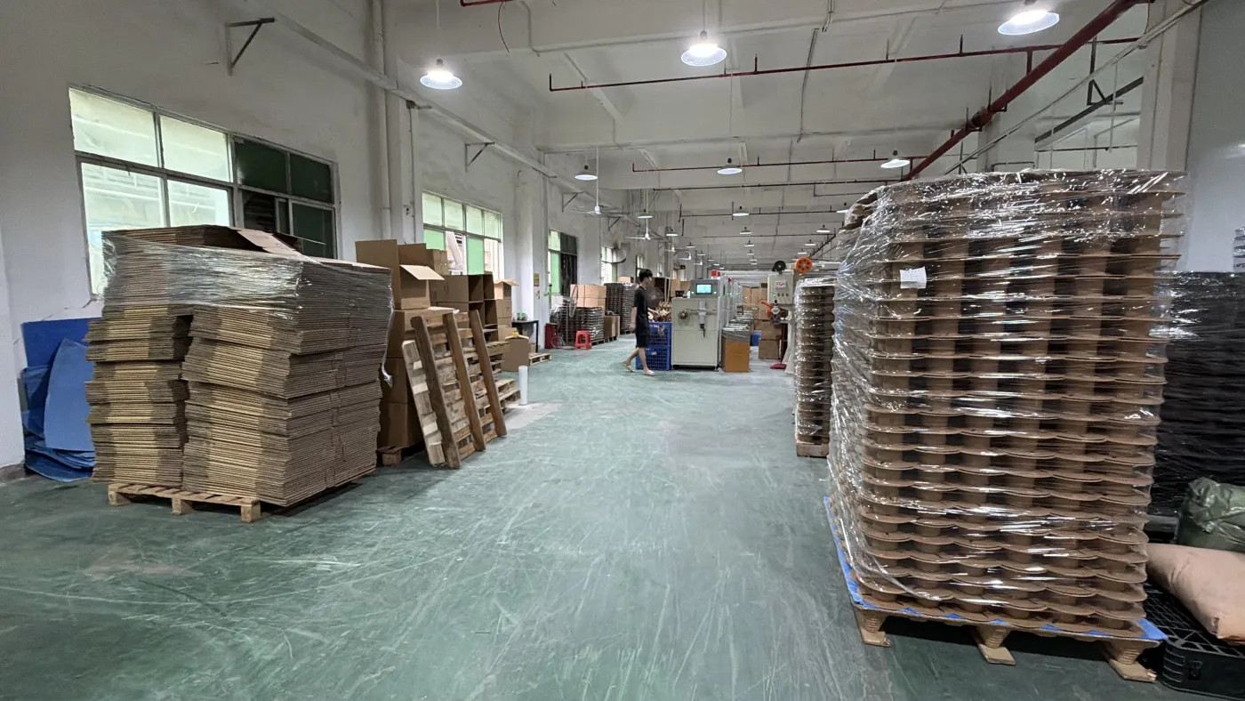 Packaging area with boxes and wrapped spool stacks
