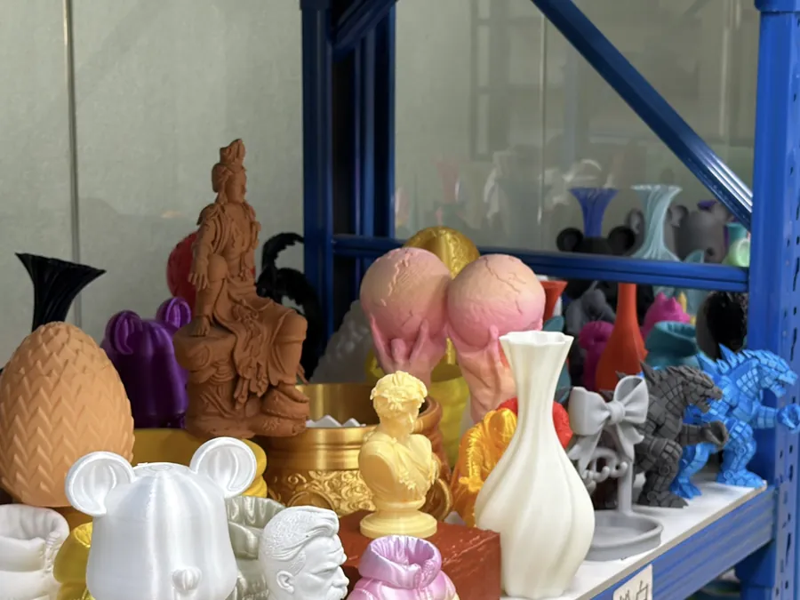 Shelf of pastel and matte-look 3D printed figurines and vases