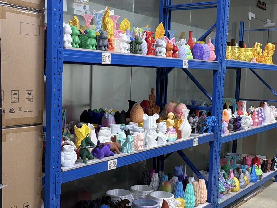 Blue shelving holding rows of multicolor small 3D printed objects