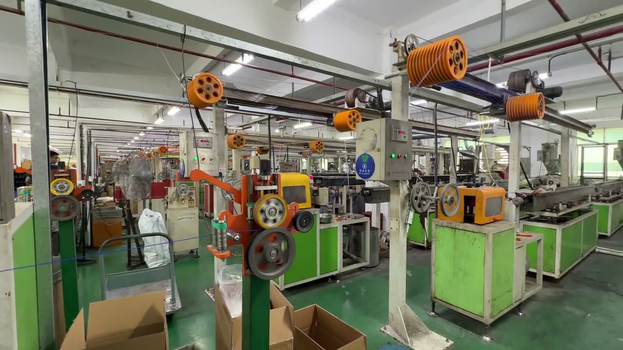 Filament extrusion line producing spools in a production facility